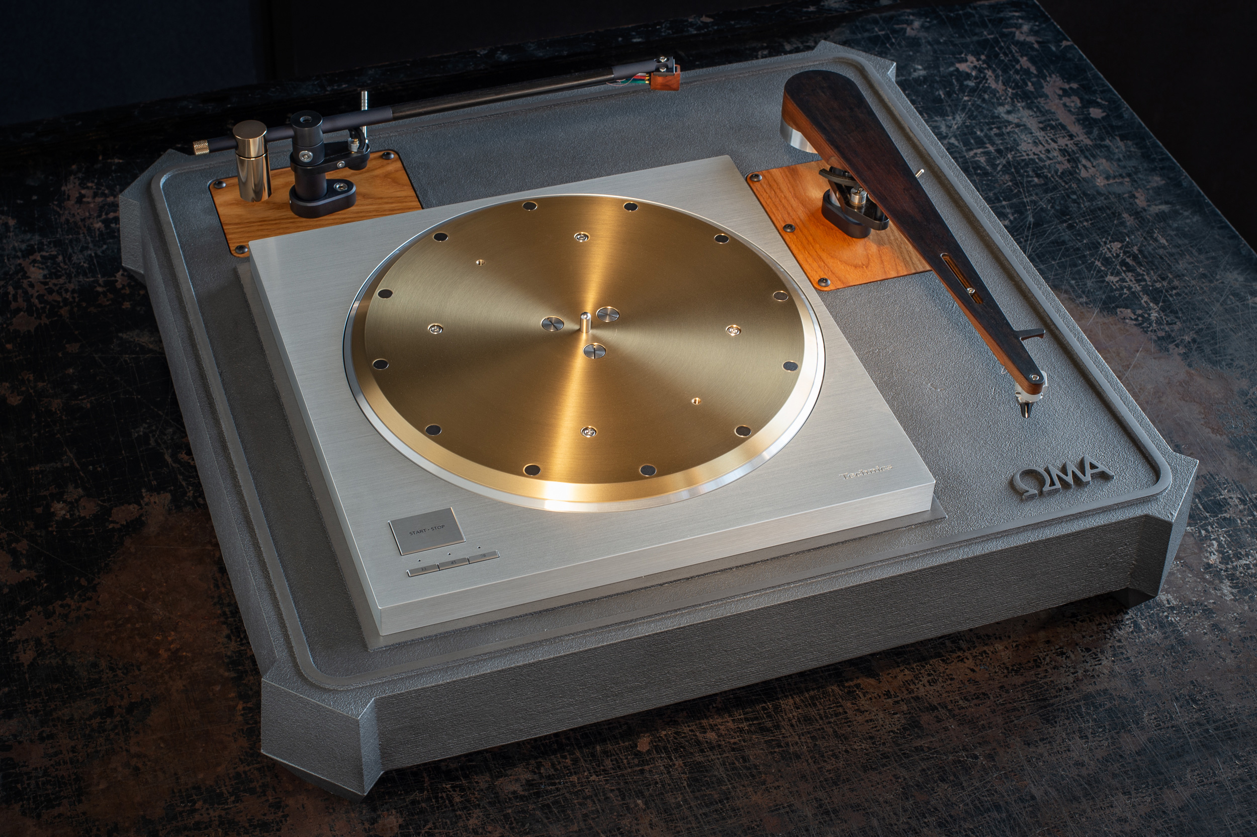 ****We also offer the OMA SP10R plinth system in a two arm configuration. This substantially increases the size, weight and cost- 23" depth x 25" width x 5" height (top of platter). Shown here with Schroeder CB and Model B tonearms.